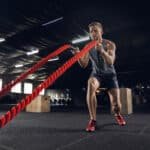 man exercising with ropes