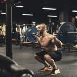 man doing barbell squat