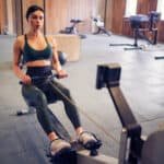 woman using rowing machine